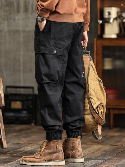 Pantalon cargo fuselé à taille élastiquée et boutons décoratifs pour homme